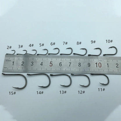 Set of fishing hooks with size markings on a ruler against a light gray background
