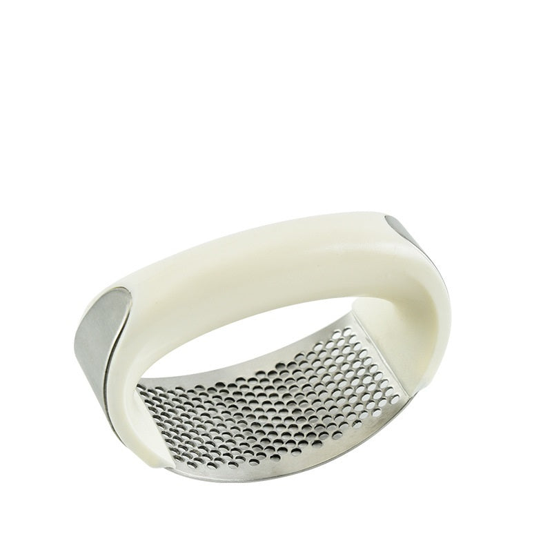 White garlic press on a white background